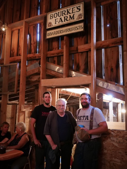 Three Generations of Lesters, standing under the Bourke's Farm sign, salvaged during the barn reno.